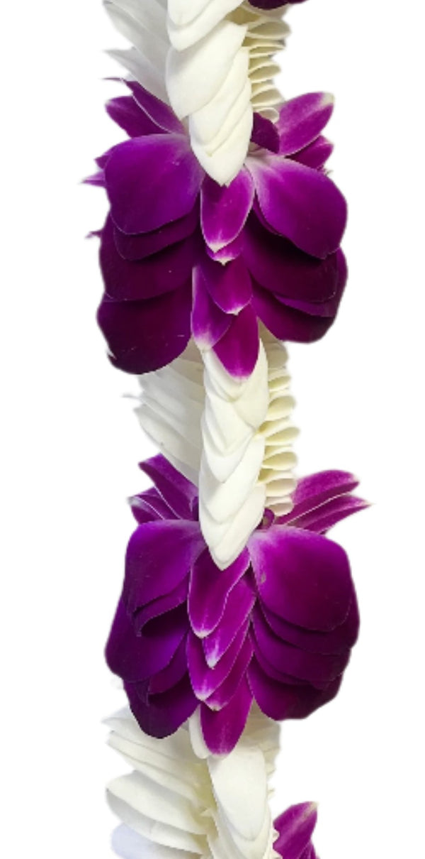 Close-up of the deluxe lei showing the textured layering and color transitions between the white and purple orchid petals.