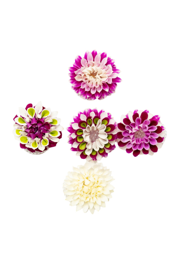 A collection of colorful floral orchid wristlets and hair clips against a white background.