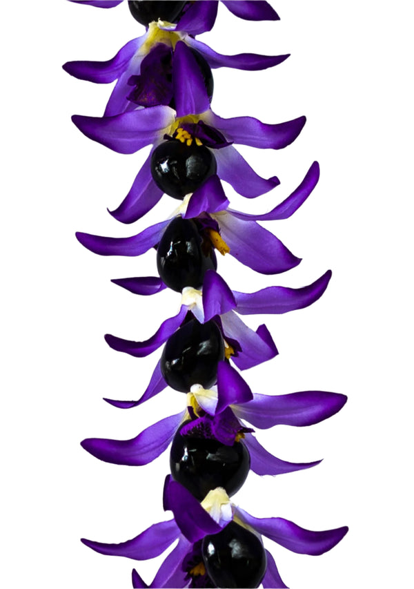 Close-up of a lei featuring silk purple orchids paired with glossy black kukui nuts, set against a white background.