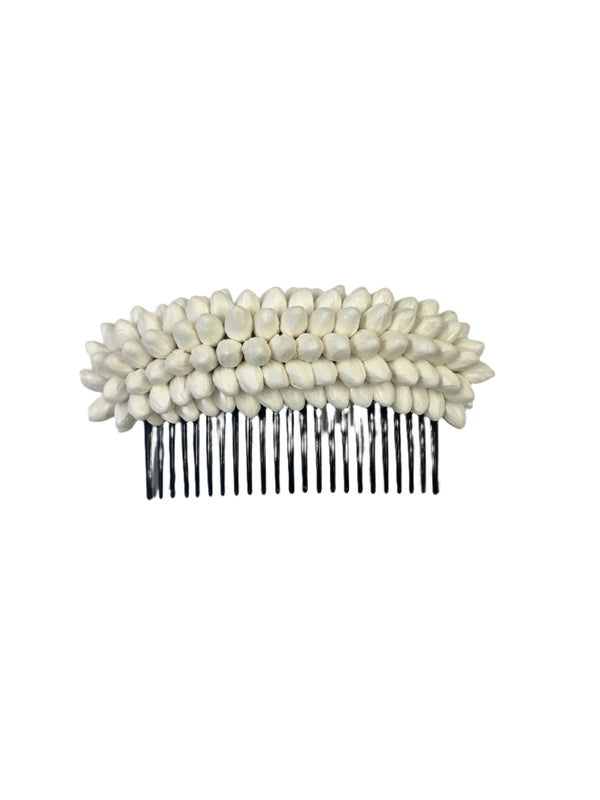 Small hair comb with white paper pikake buds on a white background.