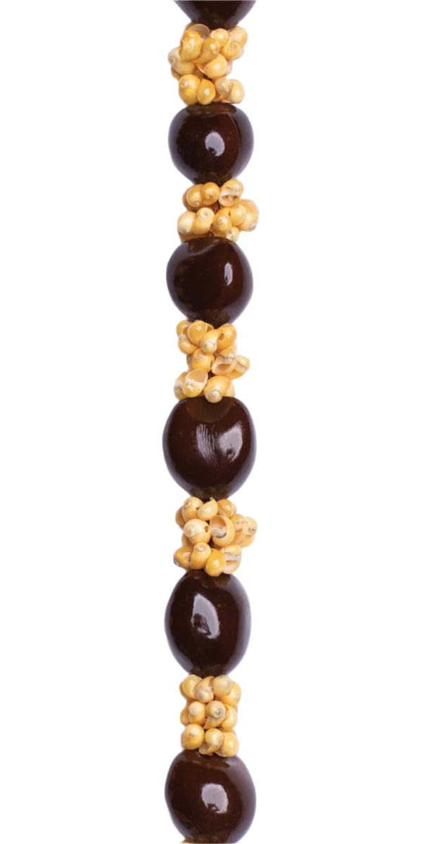 Close-up of lei showcasing alternating glossy Kukui nuts and yellow Mongo shells.