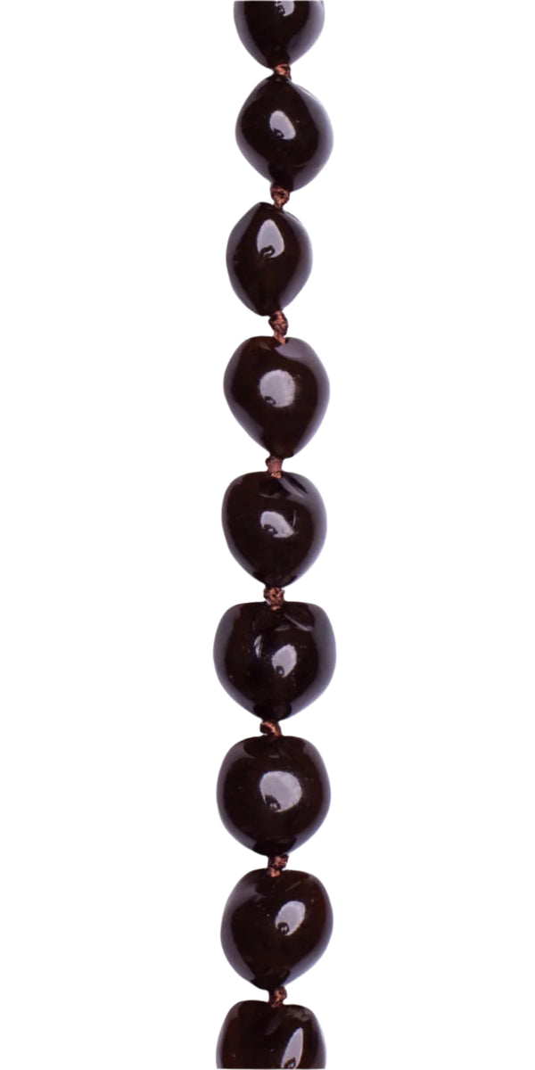 A close-up of a brown kukui nut lei showing off the smooth, glossy finish.