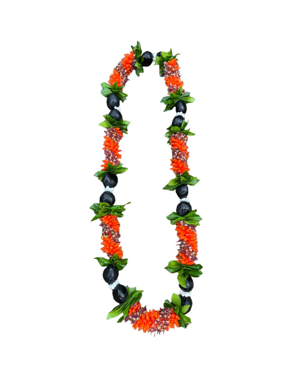 Lei made with different shades of cigar flowers, accented by green ti leaves, black Kukui nuts, and white Mongo shells.