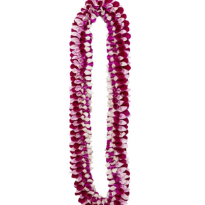 Lei made of dark purple, pink, and white orchid petals arranged in a spiral-like pattern.