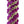 Close-up of a spiral orchid lei with purple and jade green petals arranged in a striking alternating diagonal pattern, set against a white background.