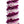 Close-up of a purple premium spiral orchid lei showing an intricate pattern of small purple petal sections alternating with larger light-colored orchid blossom backings, highlighting texture and detail.