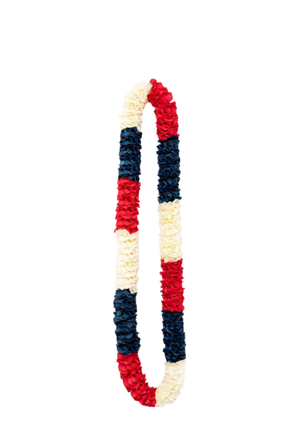 Natural white and sprayed red and blue premium spiral orchid lei featuring an intricate pattern with large alternating sections of red, white, and blue.