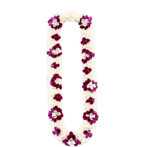 Premium spiral orchid lei featuring white petals accented by clusters of purple petals arranged in a diamond-like pattern.