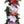 Close-up of a head lei made with different colored orchids and green fern leaves, showing the delicate floral and foliage details against a white background.