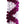 Close-up of a white orchid lei with deep purple zigzag patterns arranged spirally, highlighting the intricate petal arrangement against a white background.