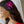 Girl with long hair wearing a fuchsia orchid hair clip.