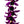 Close-up of a lei featuring vibrant silk fuchsia orchids and glossy black kukui nuts, set against a white background.