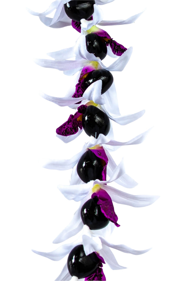 Close-up of a lei featuring silk white orchids with purple centers and glossy black kukui nuts, set against a white background.