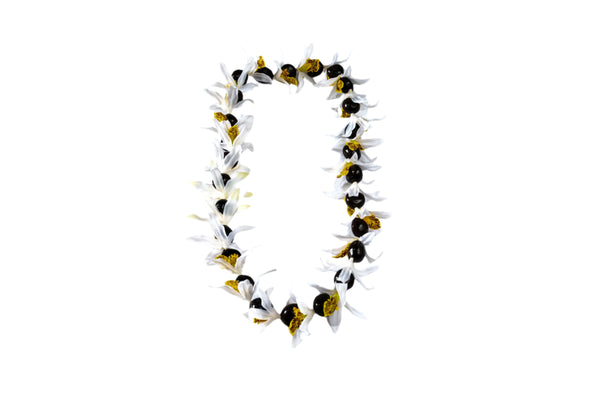 Lei made of silk white orchids with yellow centers and black kukui nuts, displayed against a white background.