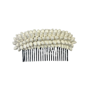 Small hair comb with white paper pikake buds on a white background.