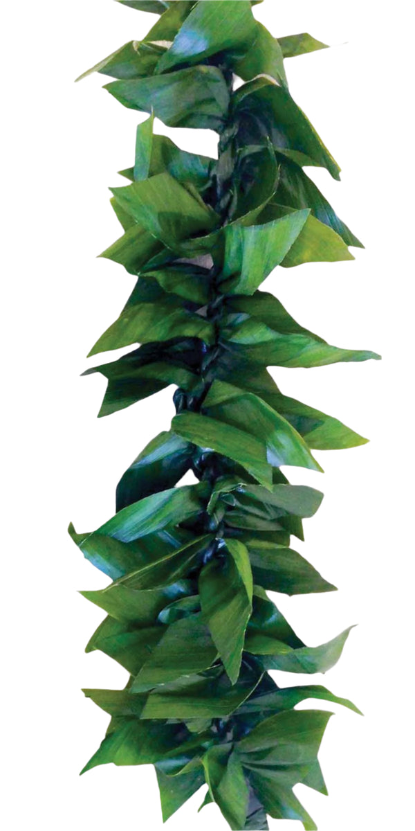 Close-up of a fresh green ti leaf maile lei, showing the layered leaves and vibrant texture against a white background.